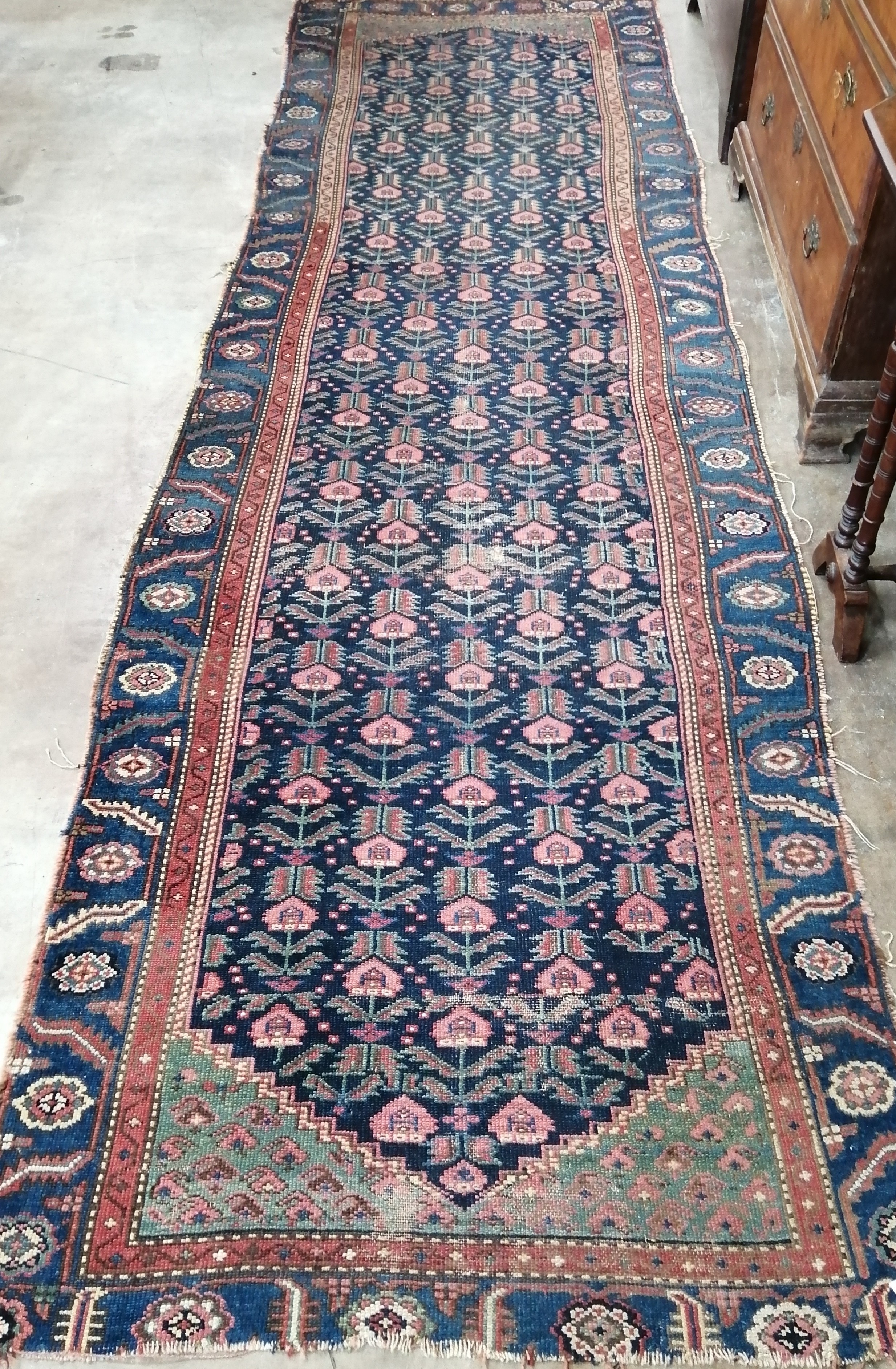 A Caucasian runner, woven with rows of hooked botehs, 370 x 102cm